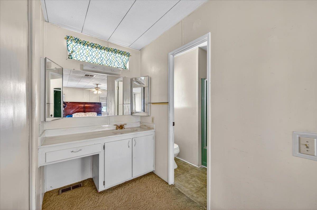2706 West Ashlan Avenue, Unit 86 Fresno, CA 93705 - Photo 35 of 61 a spacious bathroom with a double vanity sink and a mirror