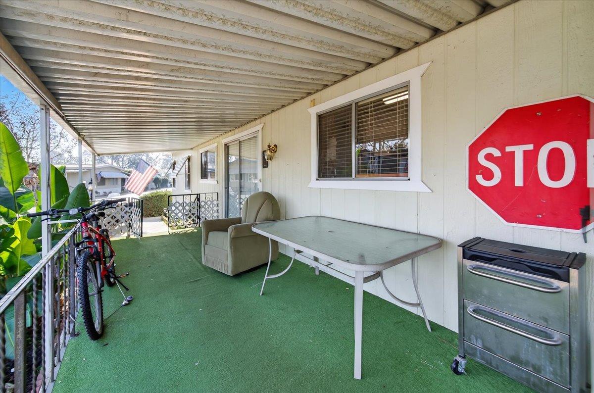 2706 West Ashlan Avenue, Unit 86 Fresno, CA 93705 - Photo 40 of 61 a view of a porch with furniture and a yard