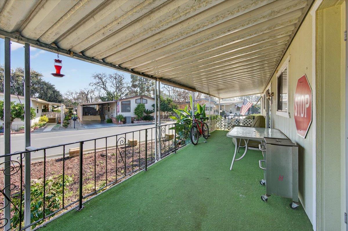 2706 West Ashlan Avenue, Unit 86 Fresno, CA 93705 - Photo 44 of 61 a view of a porch with furniture and garden