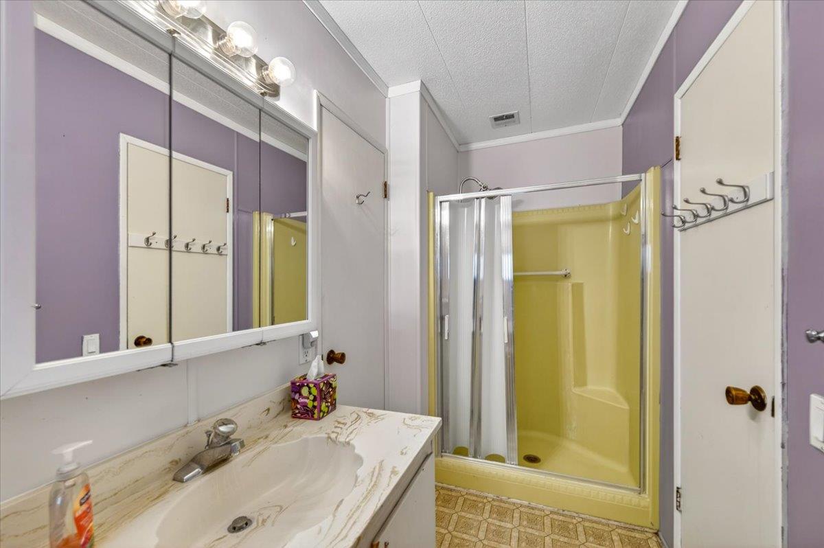 2706 West Ashlan Avenue, Unit 86 Fresno, CA 93705 - Photo 48 of 61 a bathroom with a tub sink shower and mirror
