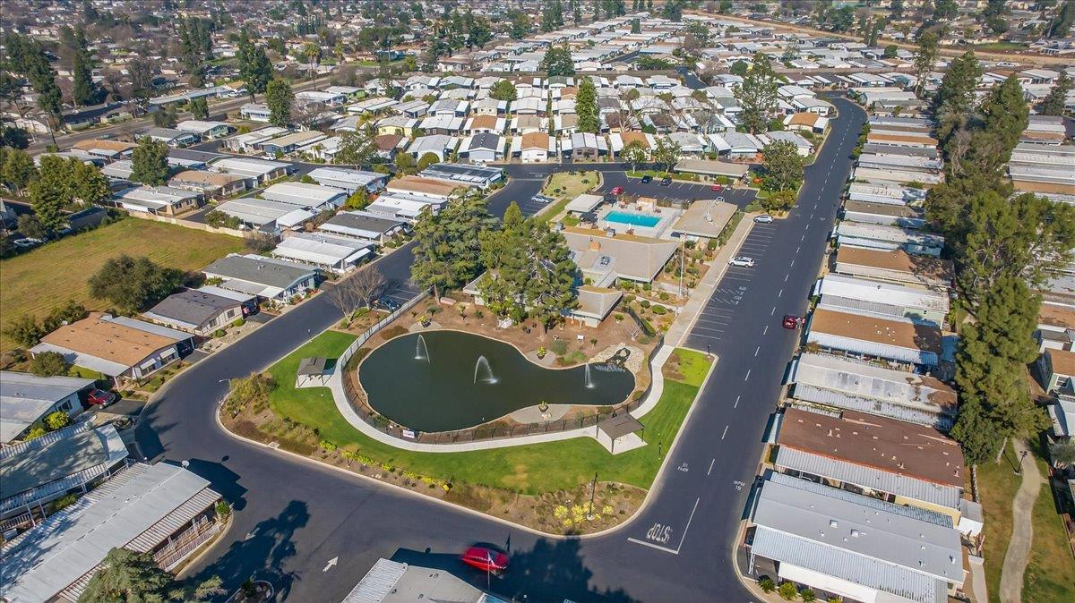 2706 West Ashlan Avenue, Unit 86 Fresno, CA 93705 - Photo 50 of 61 an aerial view of a house with swimming pool outdoor seating and yard