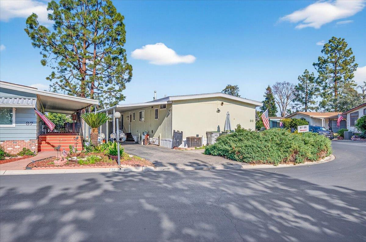 2706 West Ashlan Avenue, Unit 86 Fresno, CA 93705 - Photo 9 of 61 a view of a house with a porch and garden