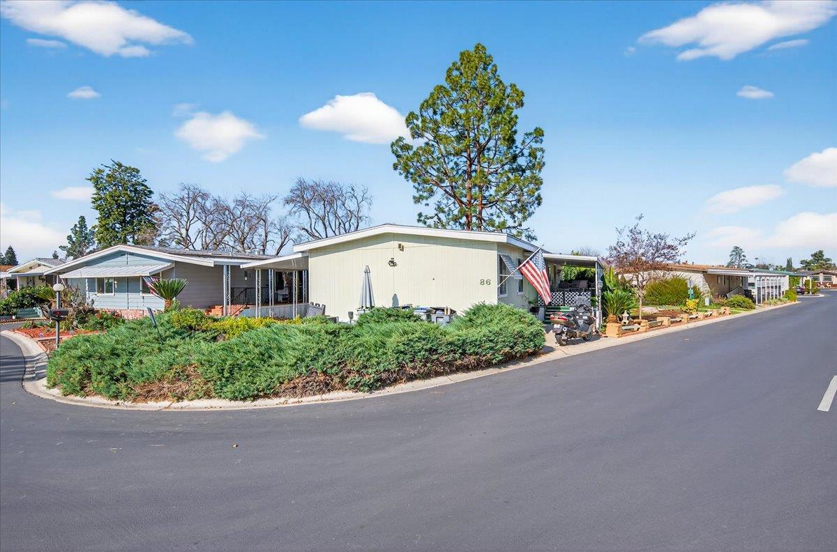 2706 West Ashlan Avenue, Unit 86 Fresno, CA 93705 - Photo 10 of 61 a front view of a house with a yard and potted plants
