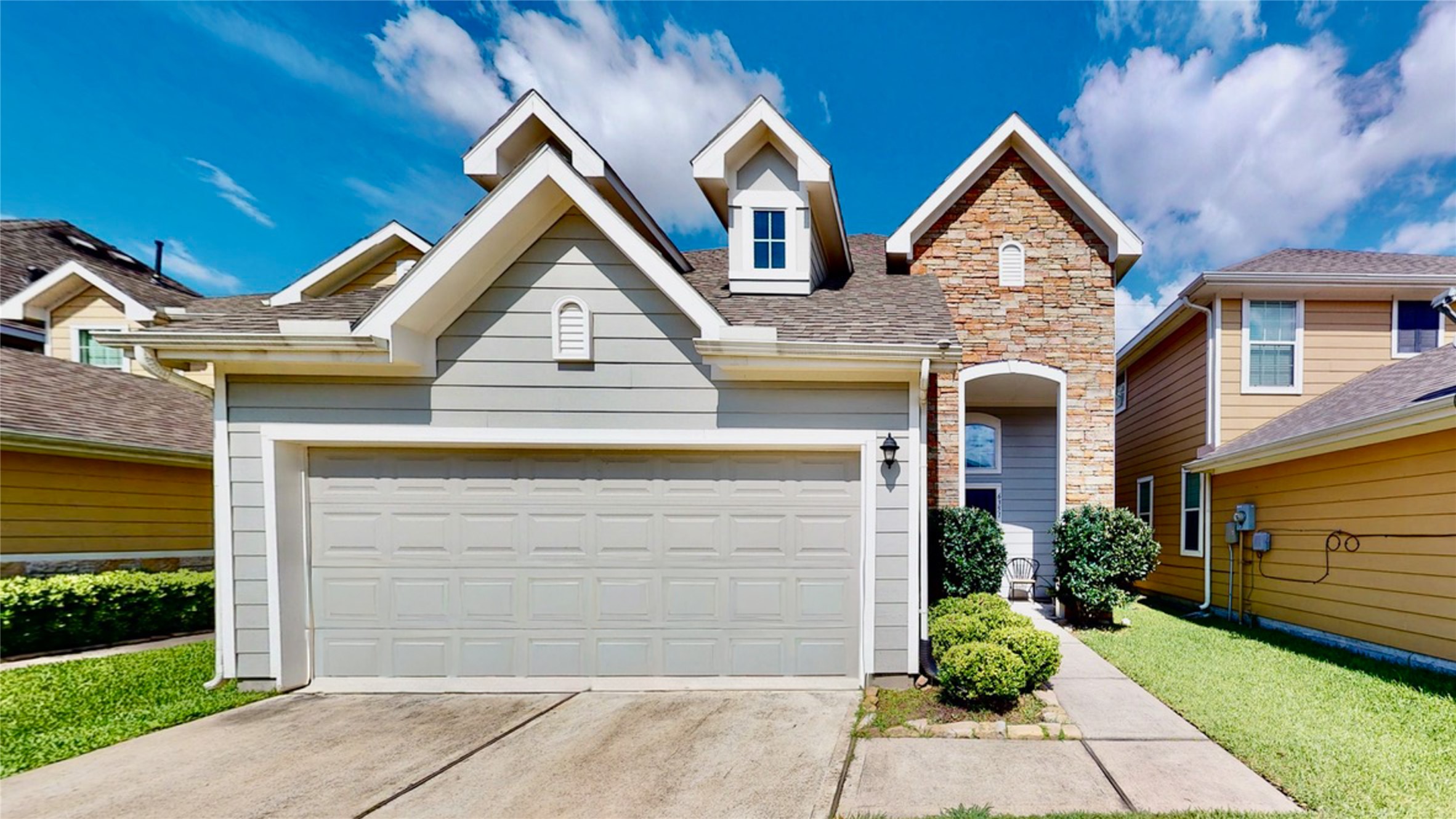 a front view of a house with a yard and garage