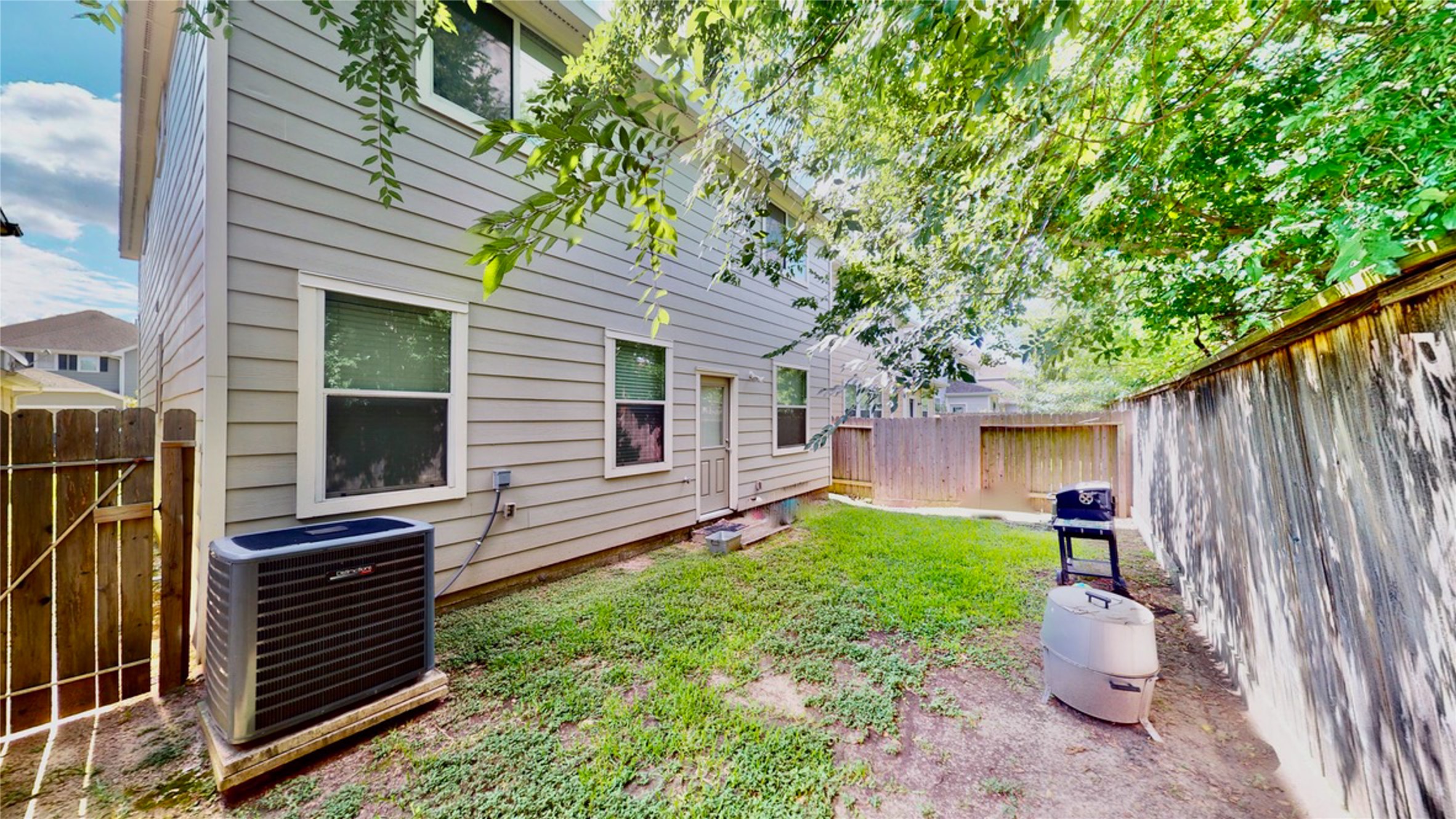 6351 Wilshire Ridge Houston, TX 77040 - Photo 22 of 24 a view of a backyard with table and chairs and a large tree