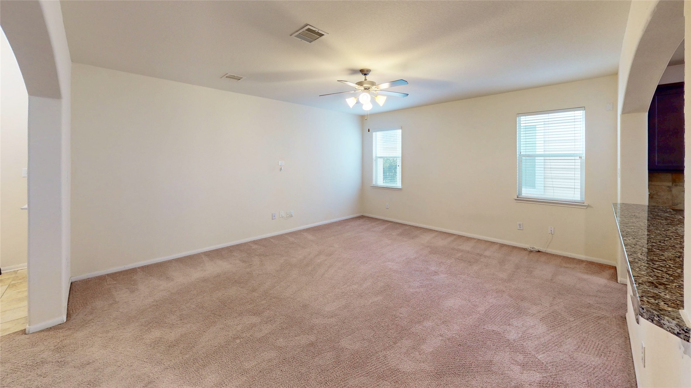 6351 Wilshire Ridge Houston, TX 77040 - Photo 3 of 24 an empty room with a chandelier fan and windows