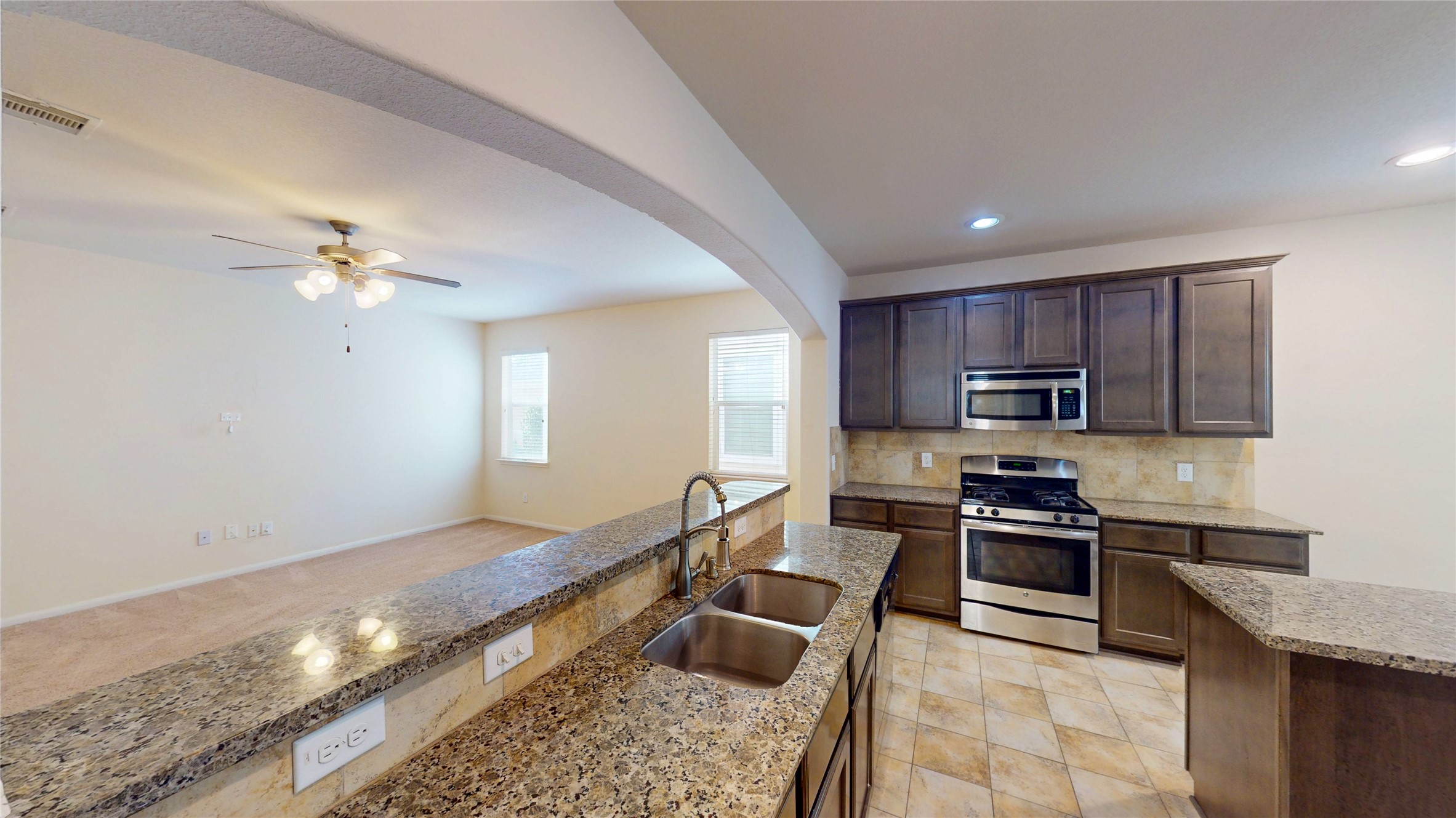 6351 Wilshire Ridge Houston, TX 77040 - Photo 4 of 24 a kitchen with stainless steel appliances granite countertop a sink dishwasher stove top oven and cabinets
