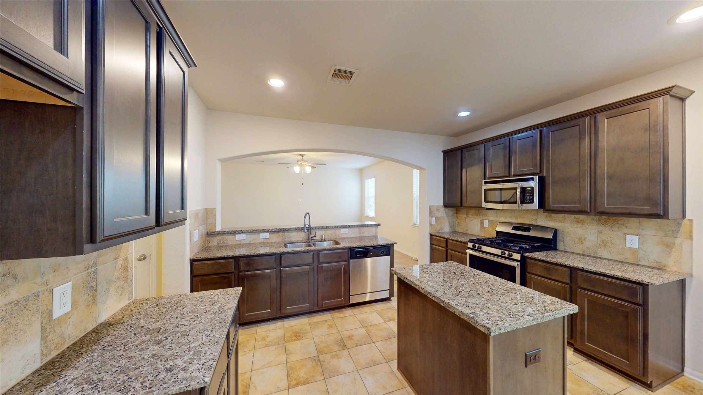 6351 Wilshire Ridge Houston, TX 77040 - Photo 5 of 24 a kitchen with stainless steel appliances granite countertop a stove top oven a sink and dishwasher