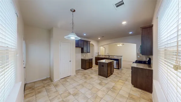 a view of a kitchen with a sink and cabinets