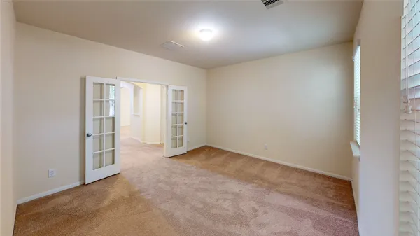 an empty room with windows and closet