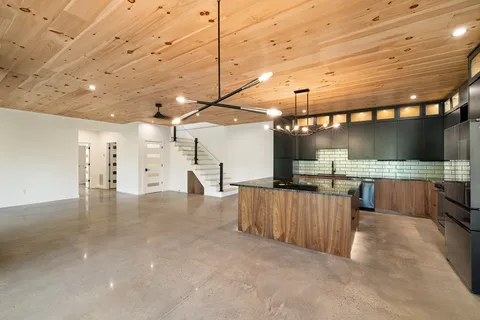a view of a room with a kitchen
