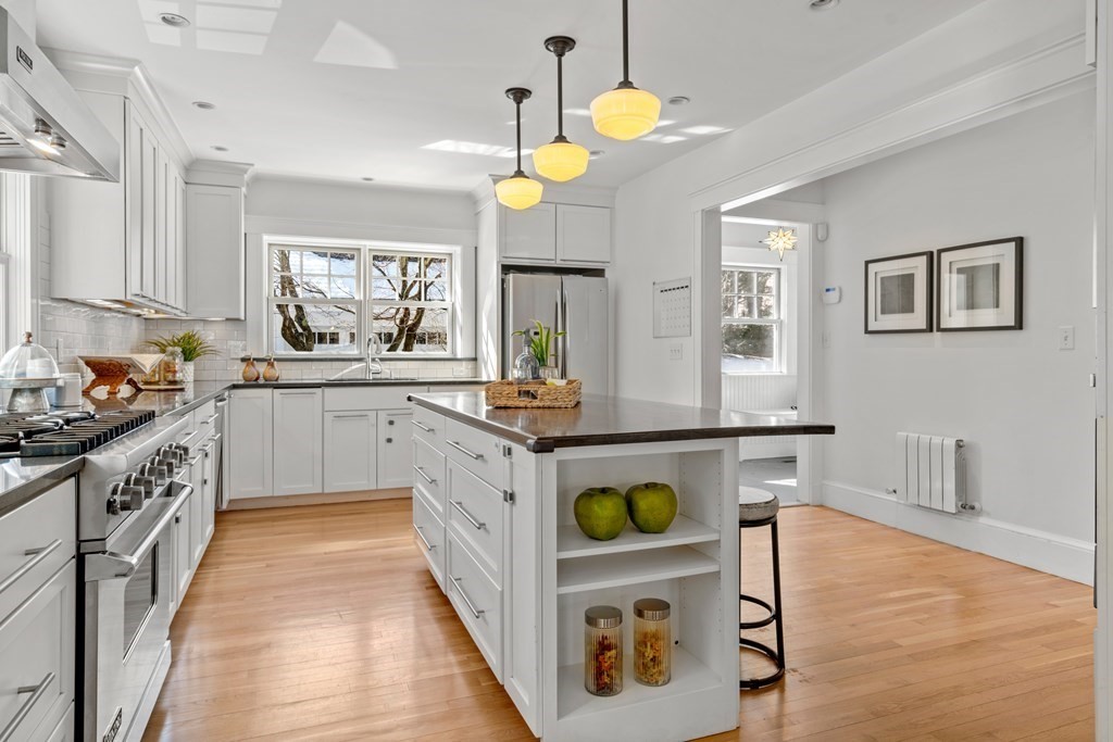84 Moffat Road Newton, MA 02468 - Photo 15 of 39 a kitchen with a stove a sink a counter top space and living room view