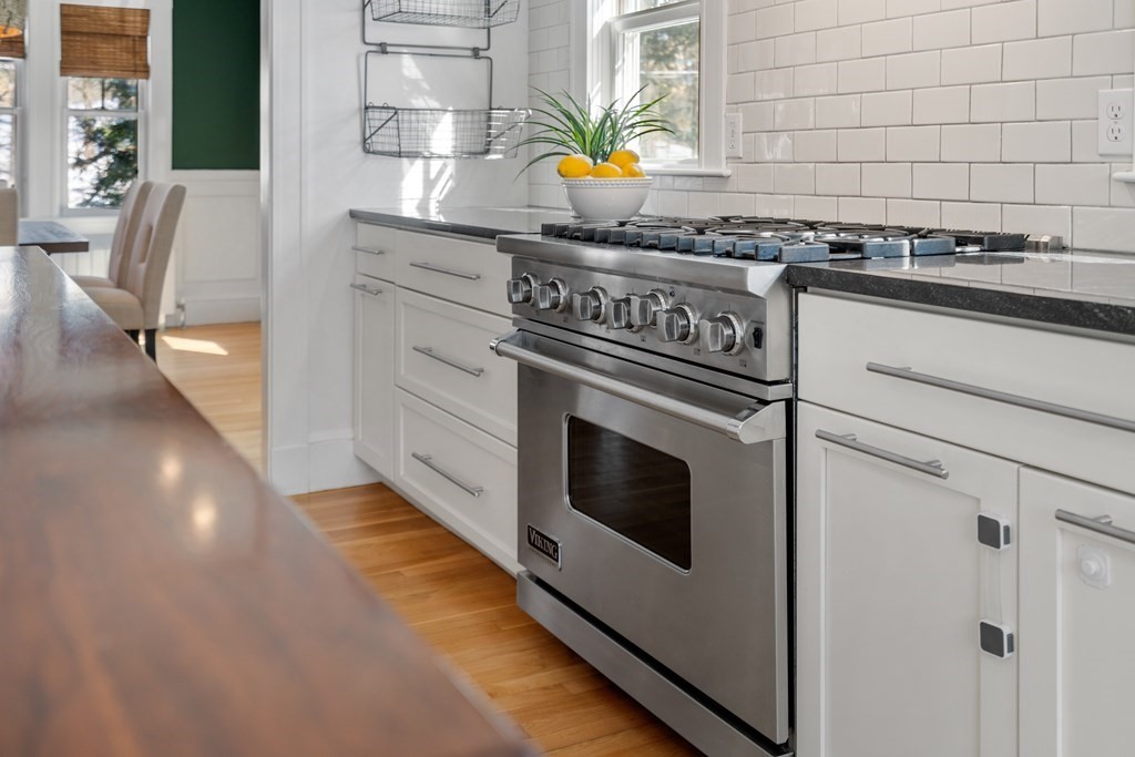 84 Moffat Road Newton, MA 02468 - Photo 17 of 39 a kitchen with stainless steel appliances granite countertop a stove and a sink