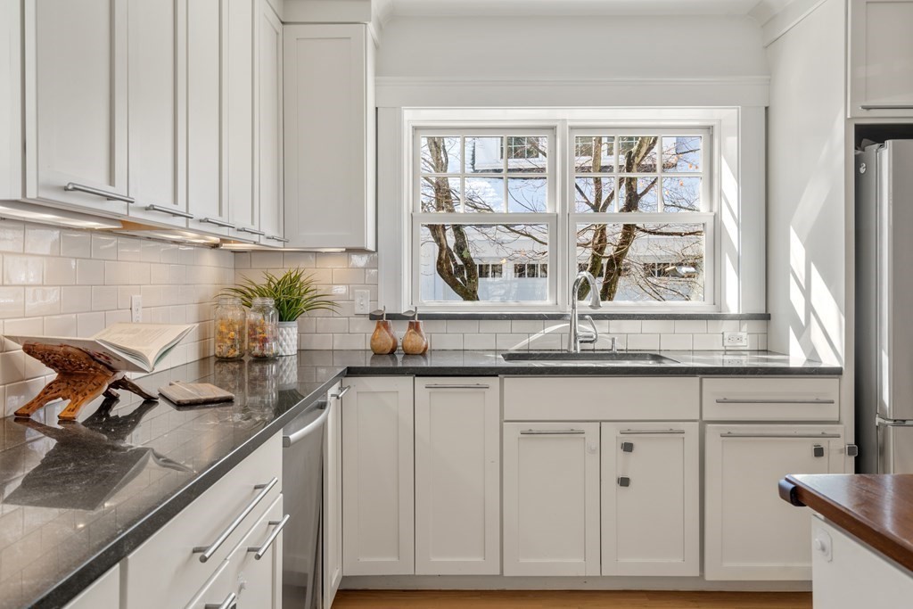 84 Moffat Road Newton, MA 02468 - Photo 18 of 39 a kitchen with stainless steel appliances granite countertop white cabinets and a window