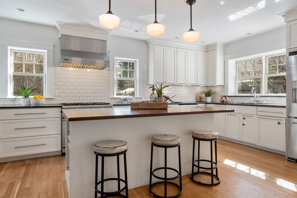 84 Moffat Road Newton, MA 02468 - Photo 19 of 39 a kitchen with a table chairs cabinets and appliances