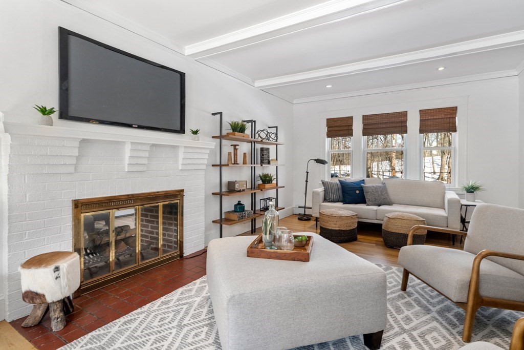 84 Moffat Road Newton, MA 02468 - Photo 8 of 39 a living room with fireplace furniture and a flat screen tv