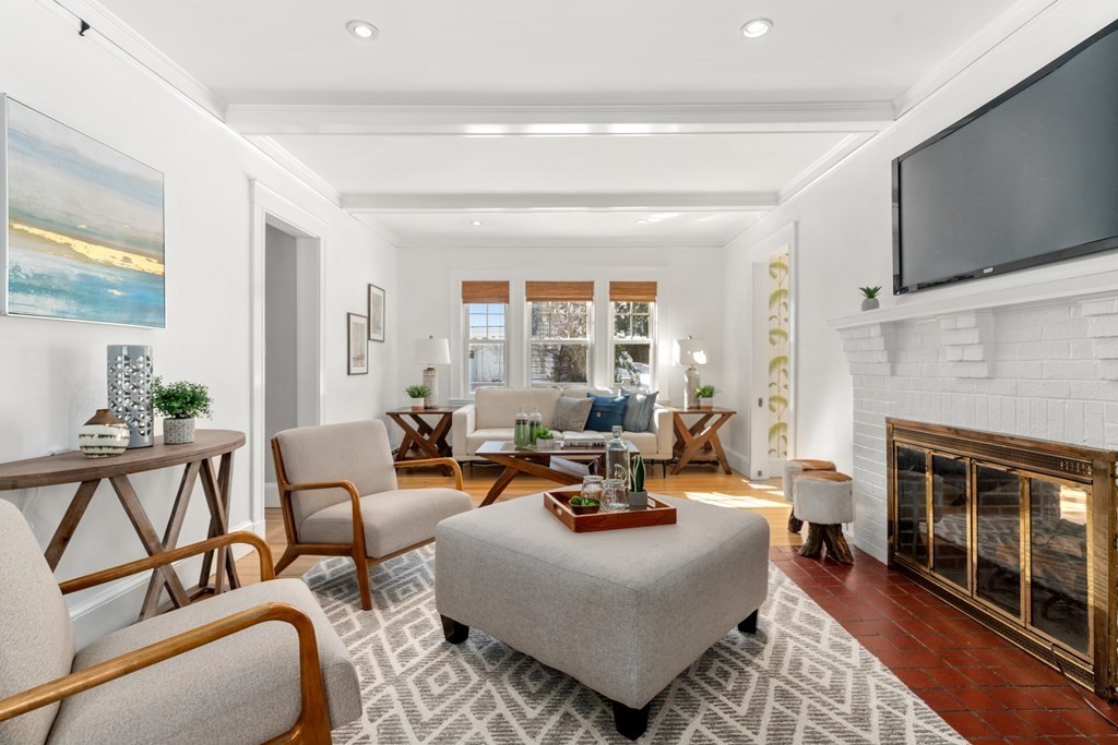 84 Moffat Road Newton, MA 02468 - Photo 9 of 39 a living room with furniture fireplace and a flat screen tv