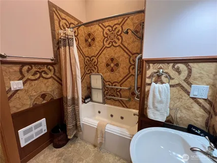 a bathroom with a sink toilet and shower