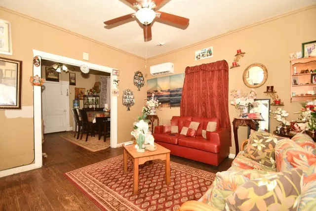 a living room with furniture and wooden floor