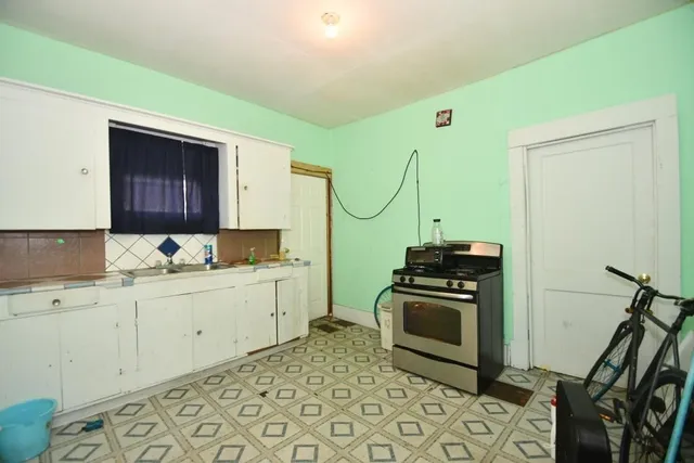 a kitchen with a stove a sink and a refrigerator