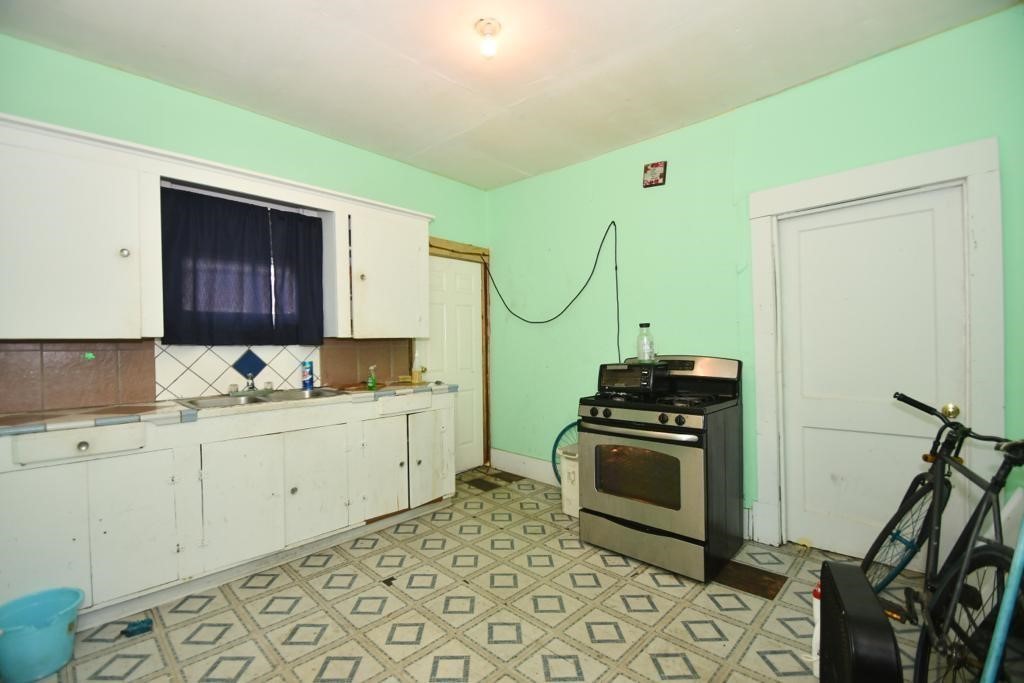 3908 Bering Street Houston, TX 77003 - Photo 20 of 21 a kitchen with a stove a sink and a refrigerator