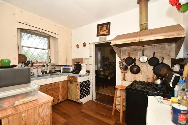 a kitchen with stainless steel appliances kitchen island granite countertop a stove a sink and a refrigerator