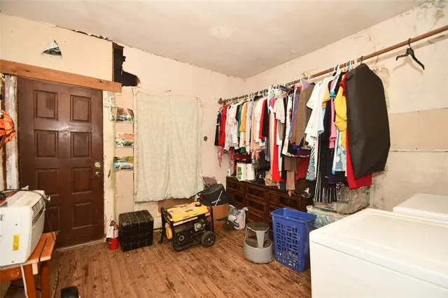 a view of walk in closet with clothes and shoes