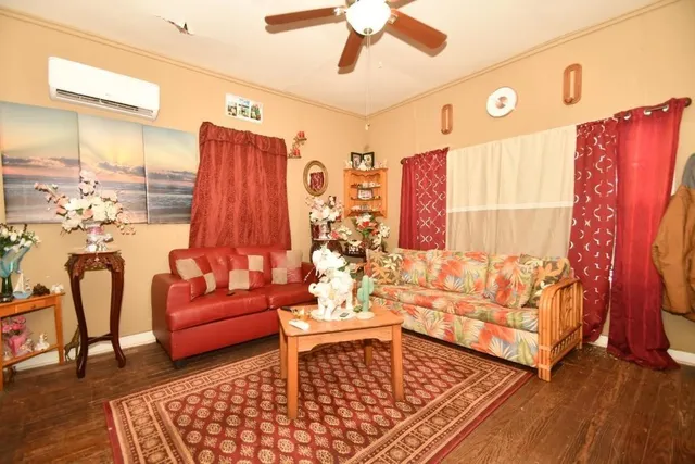 a living room with furniture rug and wooden floor