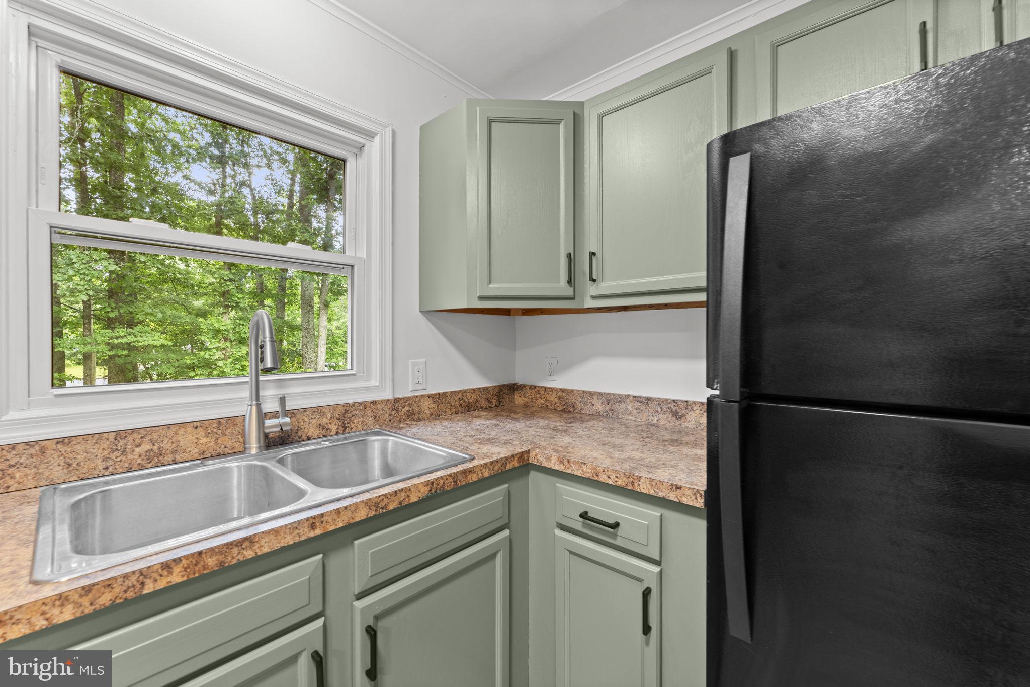 1821 James City Road Reva, VA 22735 - Photo 17 of 44 a kitchen with a sink and a refrigerator
