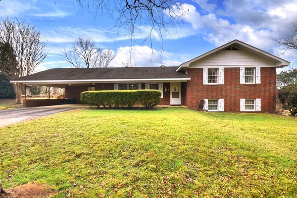 a front view of a house with a yard