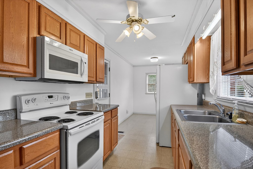 330 Colonial Avenue Copperhill, TN 37317 - Photo 21 of 37 a kitchen with stainless steel appliances granite countertop a stove a sink and a microwave