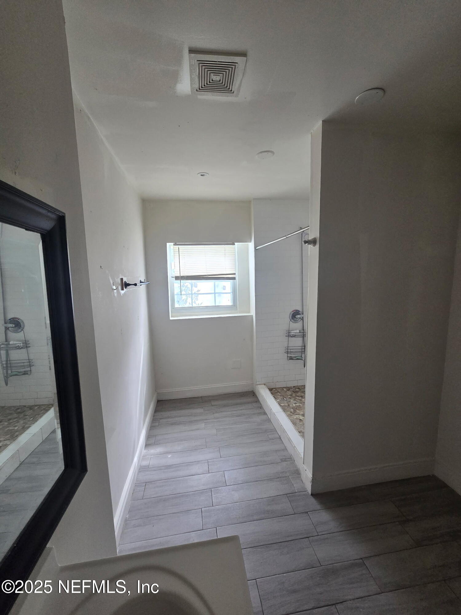 2005 Morehouse Road Jacksonville, FL 32209 - Photo 13 of 14 a view of an empty room with wooden floor and a window