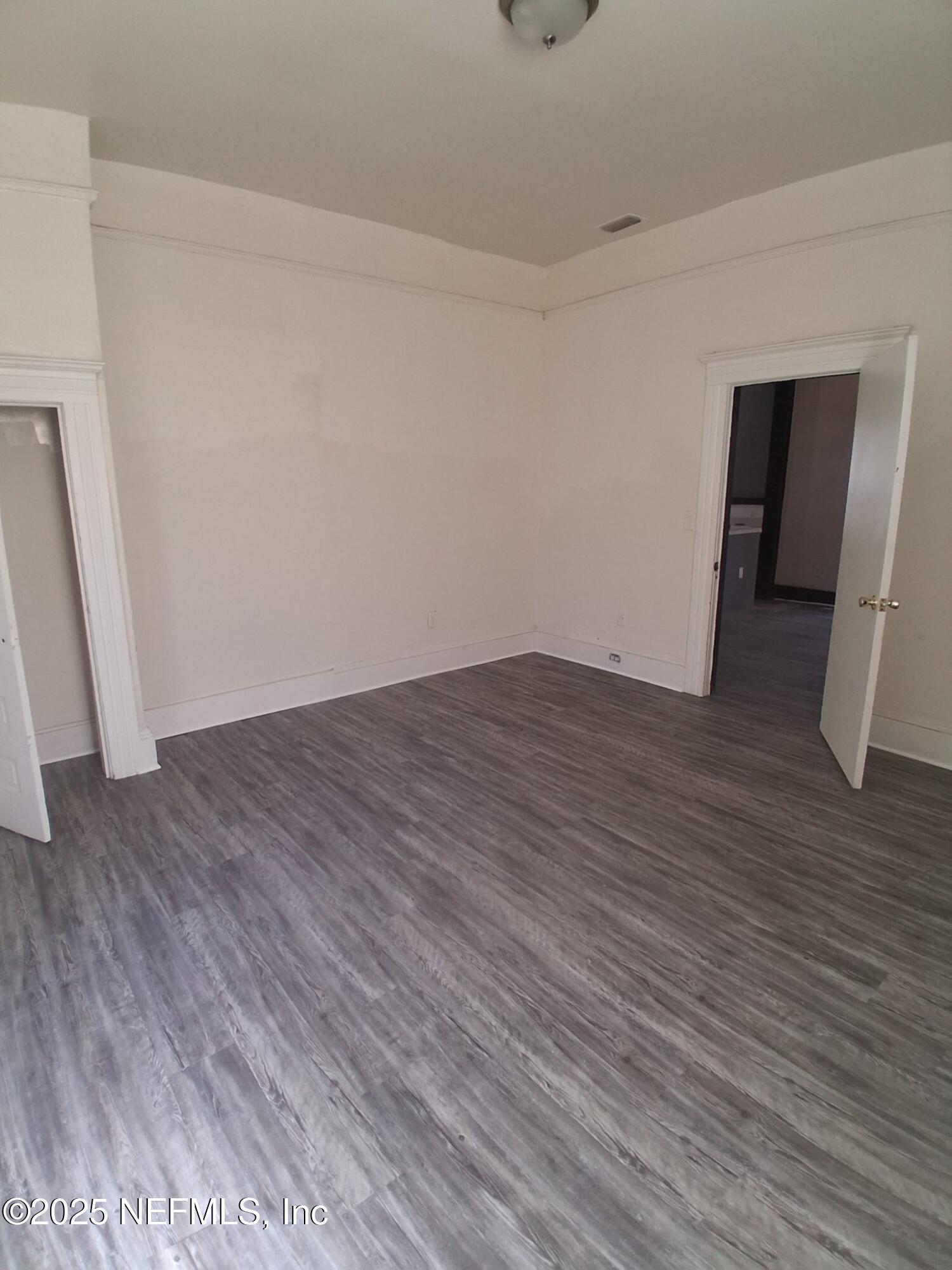 2005 Morehouse Road Jacksonville, FL 32209 - Photo 5 of 14 a view of an empty room with wooden floor and a window