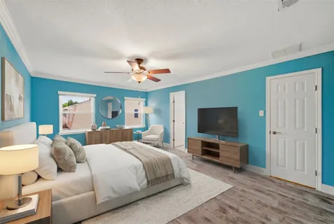 a bedroom with a bed and a flat screen tv