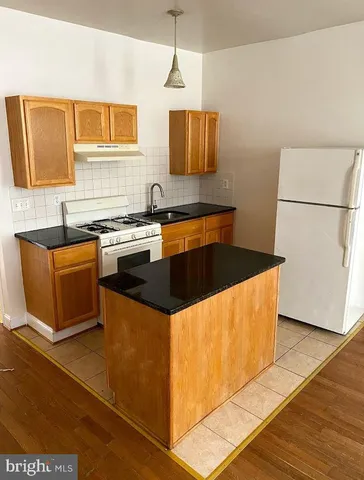 a kitchen with stainless steel appliances granite countertop a sink counter space and cabinets