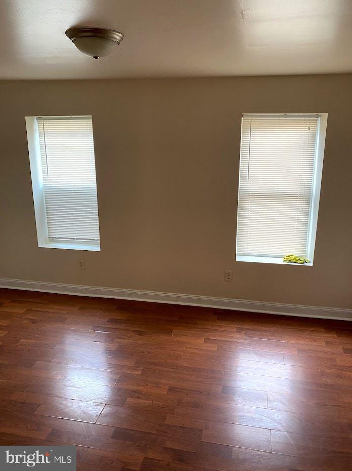 1134 West Nevada Street Philadelphia, PA 19133 - Photo 4 of 12 an empty room with wooden floor and windows