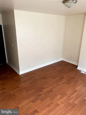 an empty room with wooden floor