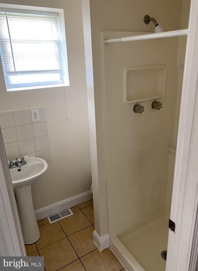 1134 West Nevada Street Philadelphia, PA 19133 - Photo 6 of 12 a bathroom with a sink a toilet and shower
