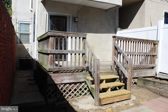a view of staircase with railing and white walls