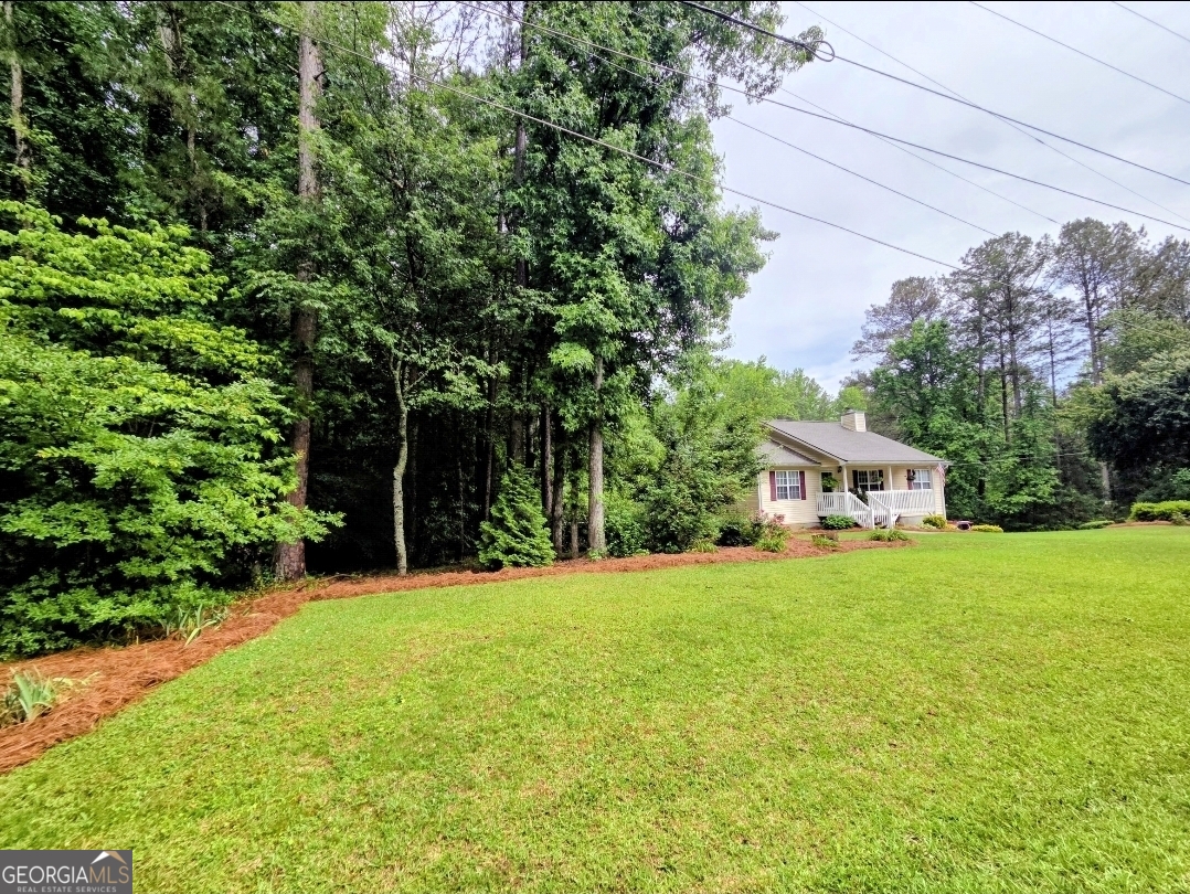 21 Baskin Heights Path Temple, GA 30179 - Photo 9 of 44 a front view of a house with a yard and trees