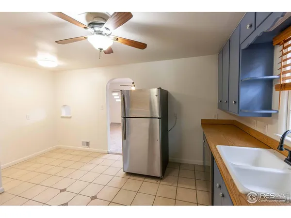 a view of kitchen with furniture and refrigerator
