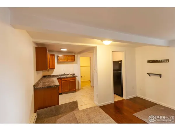 a kitchen view with stainless steel appliances granite countertop a refrigerator and a stove