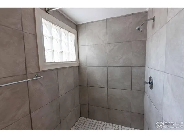 a bathroom with a window and shower