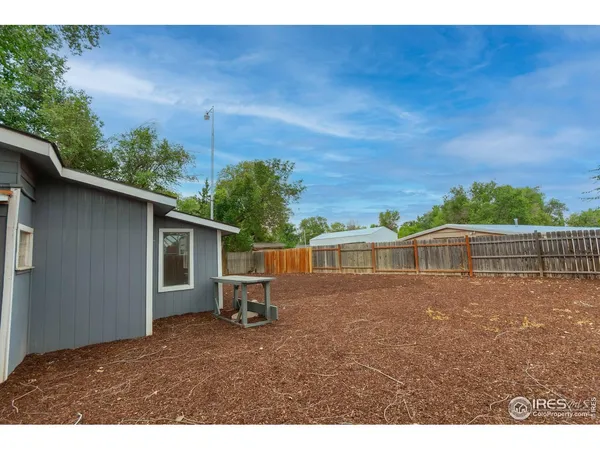 a view of house with backyard and seating area