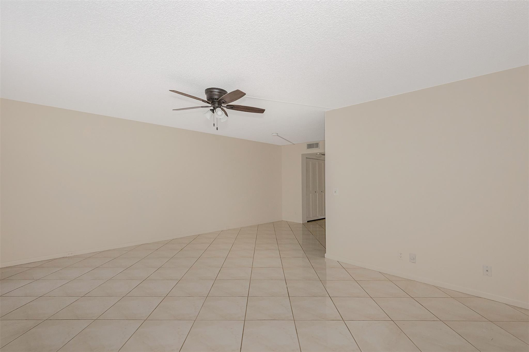 2009 Cornwall Drive, Unit 2009 Boca Raton, FL 33434 - Photo 15 of 23 a view of a room with a ceiling fan and a window