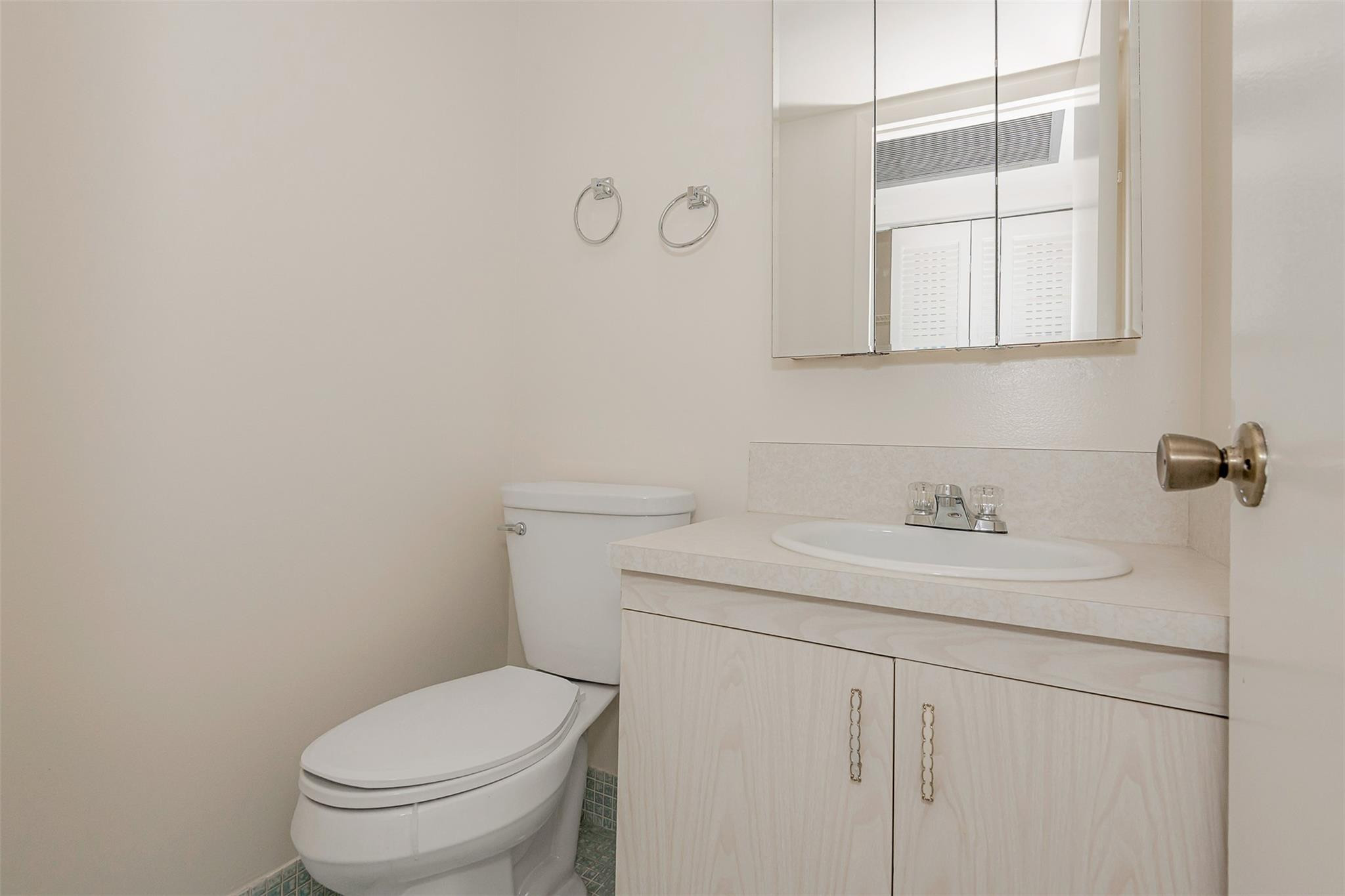 2009 Cornwall Drive, Unit 2009 Boca Raton, FL 33434 - Photo 17 of 23 a bathroom with a granite countertop toilet sink and mirror