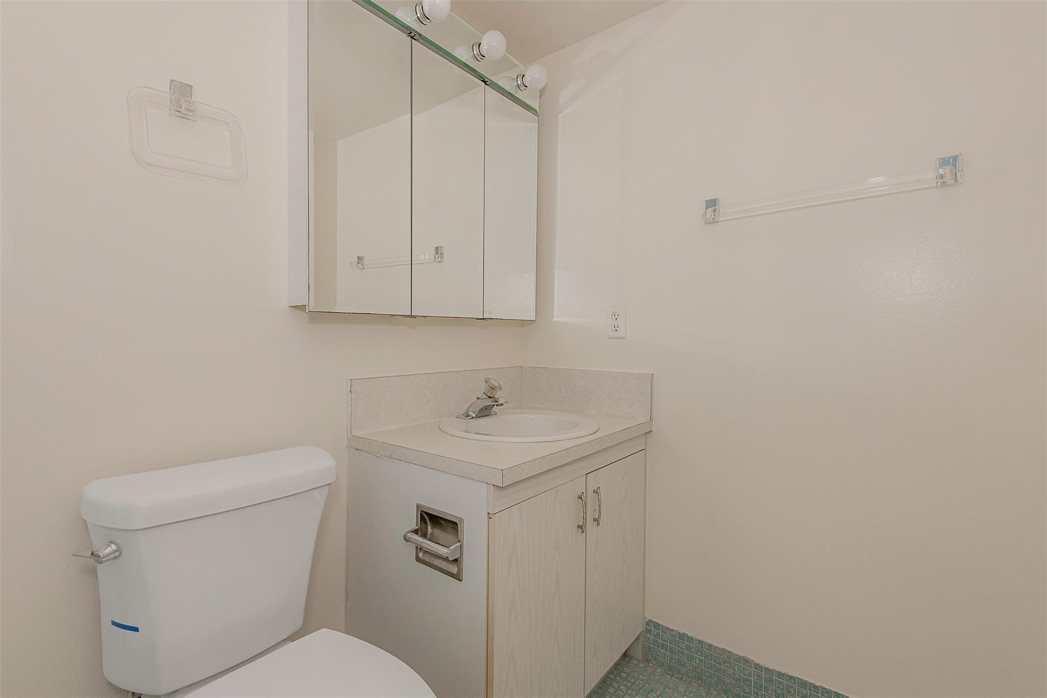 2009 Cornwall Drive, Unit 2009 Boca Raton, FL 33434 - Photo 18 of 23 a bathroom with a toilet sink and mirror