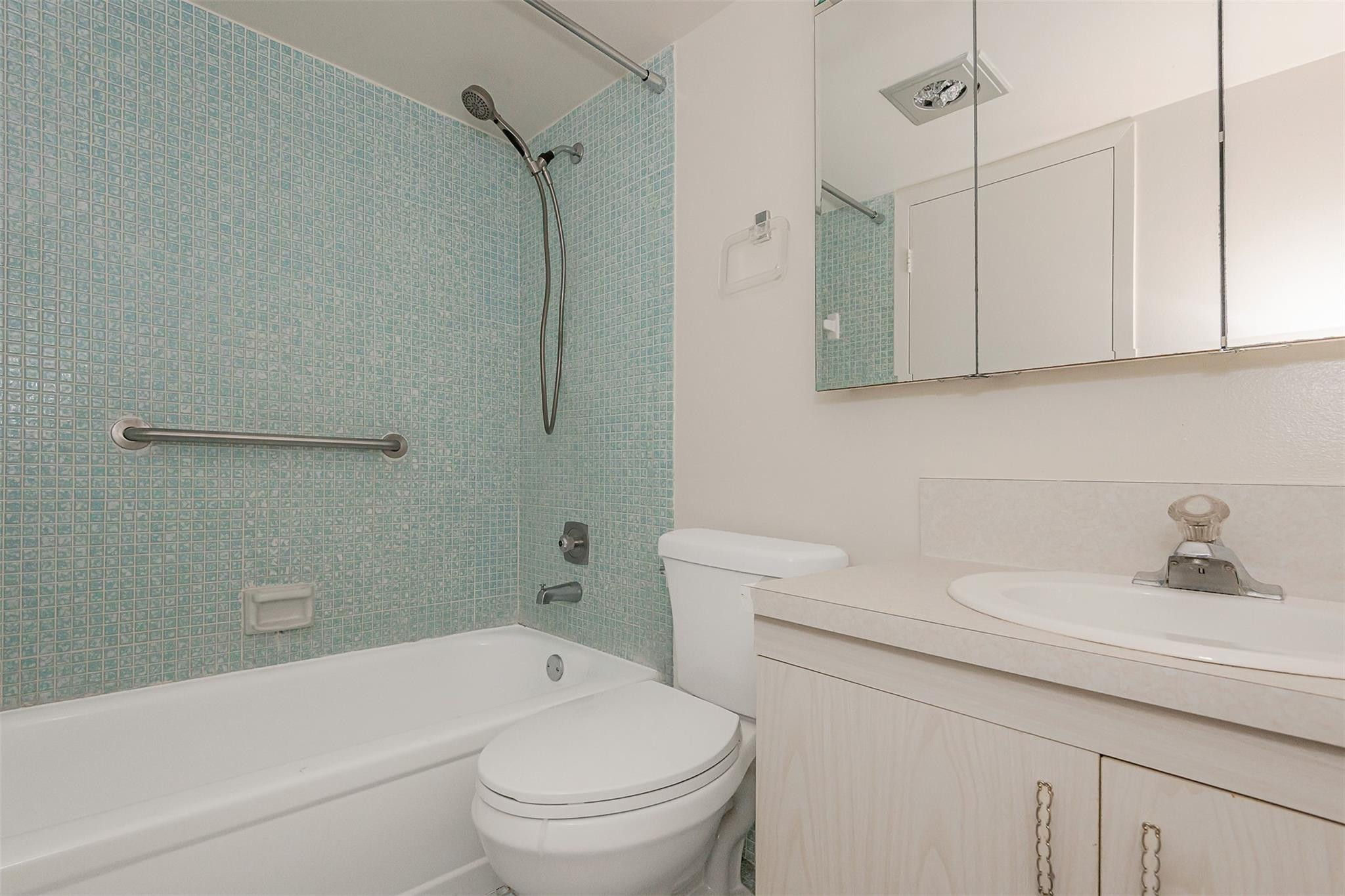 2009 Cornwall Drive, Unit 2009 Boca Raton, FL 33434 - Photo 19 of 23 a bathroom with a sink a toilet and a bathtub