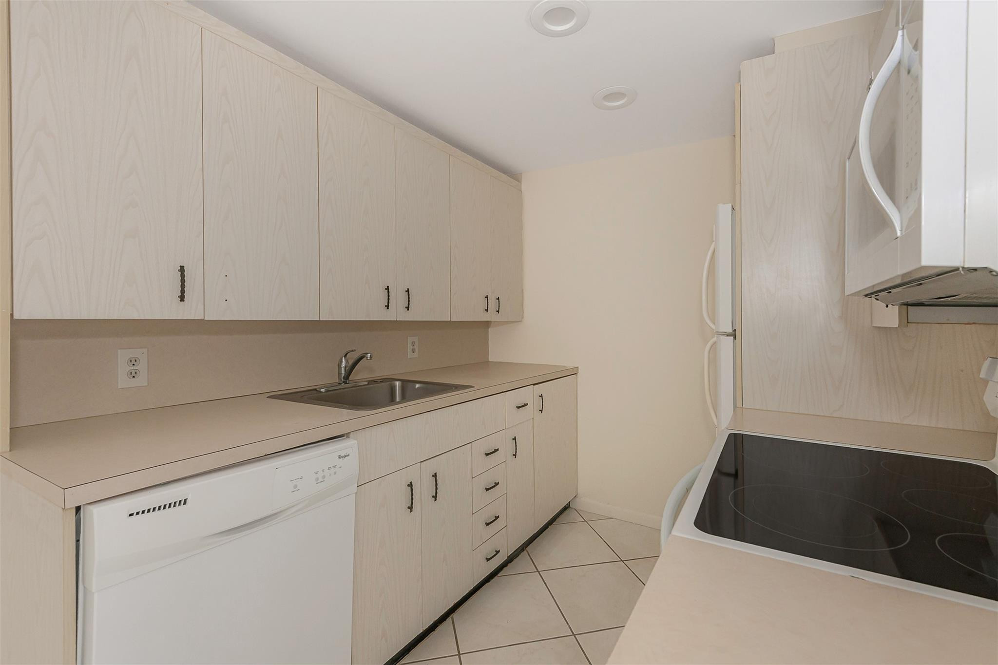 2009 Cornwall Drive, Unit 2009 Boca Raton, FL 33434 - Photo 7 of 23 a kitchen with a sink and cabinets
