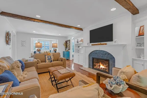 a spacious bedroom with a bed and a flat screen tv